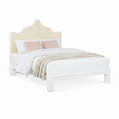 A coastal bed with a white wood frame, carved into a nicely curved shape