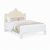 A coastal bed with a white wood frame, carved into a nicely curved shape